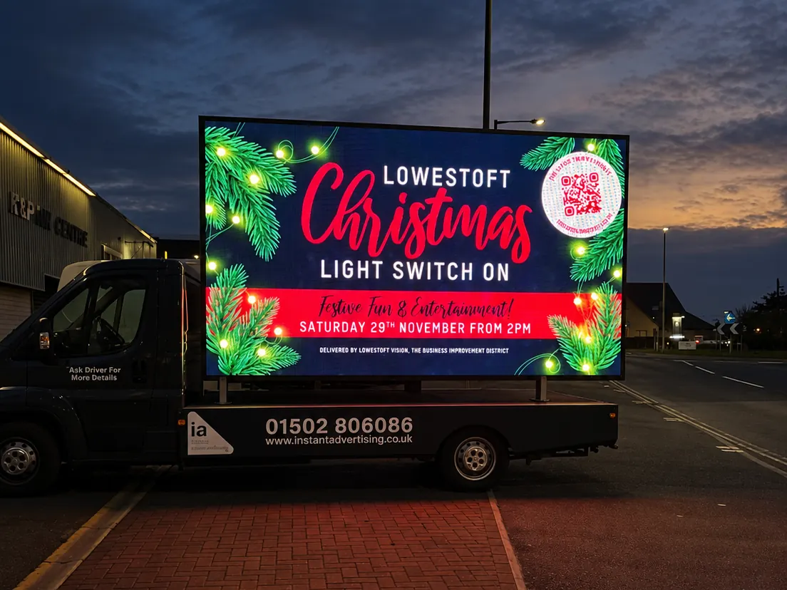 The Instant Advertising digivan at dusk with its LED screen lit