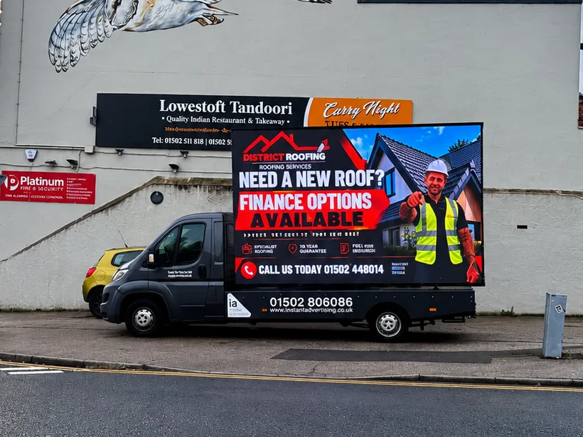 The digivan parked outside Lowestoft Tandoori showing a District Roofing advert offering finance options on new roofs