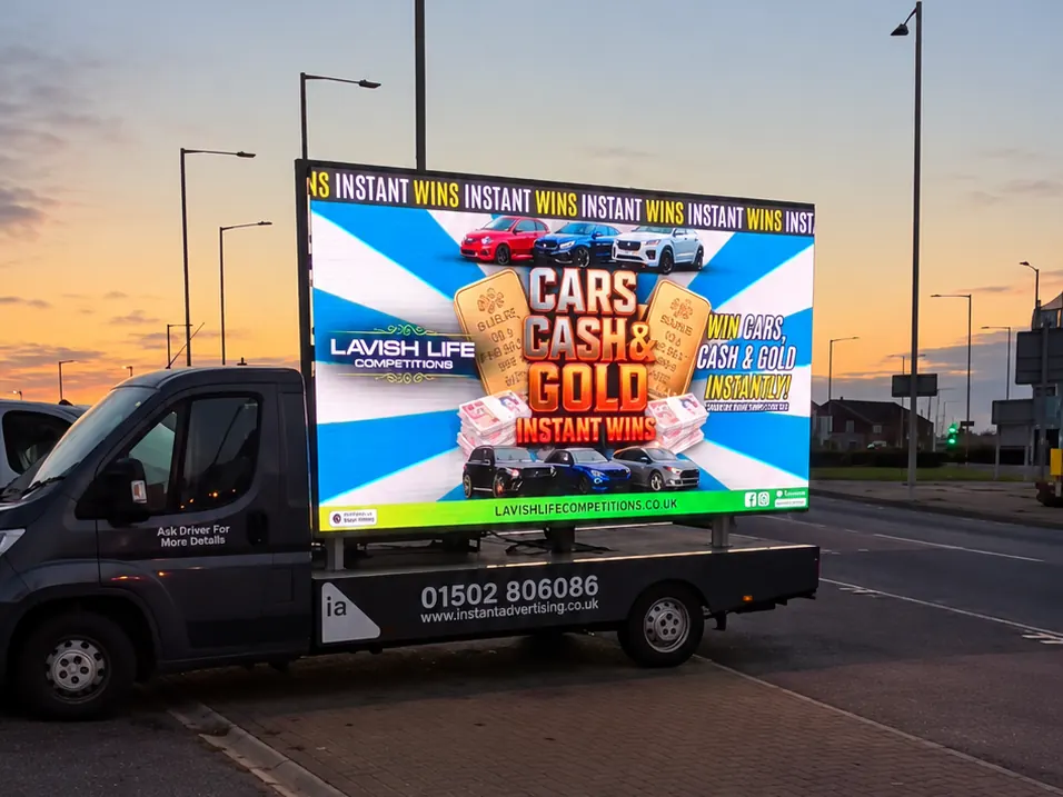 The digivan at sunset showing an advert for Lavish Life Competitions